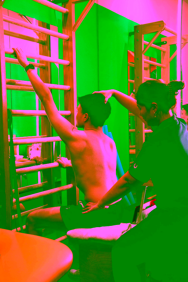 one of our Good Juju physiotherapists guiding a client through some Scoliosis Specific Exercises with care