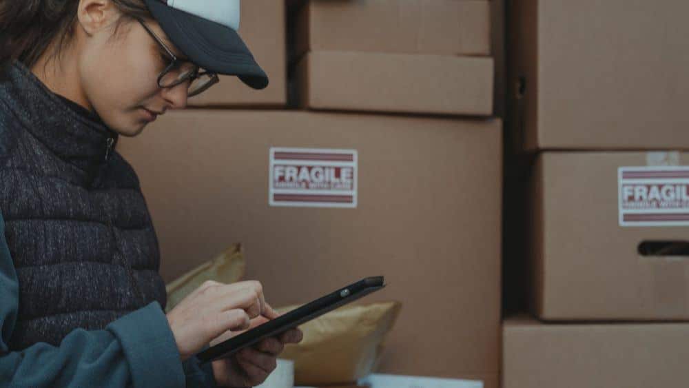 Lady inspector looking at list on a phone or tablet