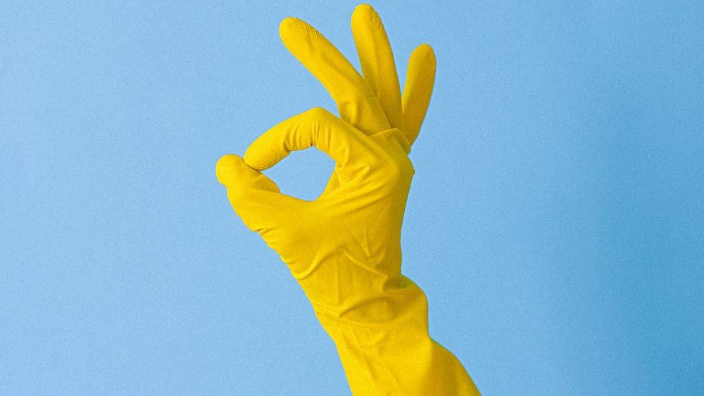 Ok approval - hand in yellow gloves doing the ok sign