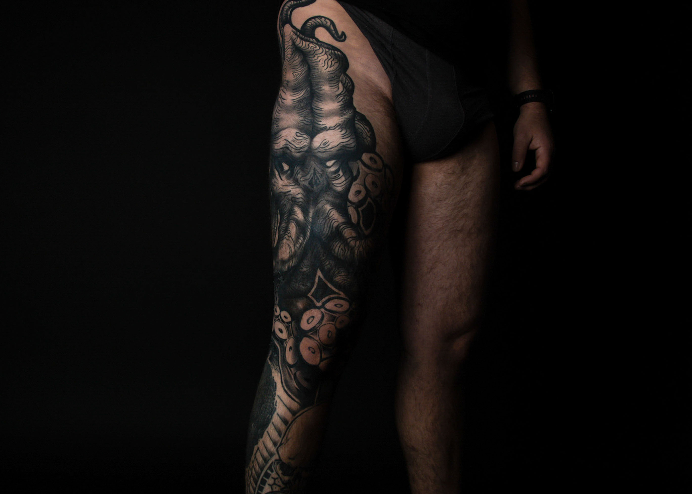 Intriguing black tattoo portraying a celestial scene of a crescent moon surrounded by stars, blending cosmic beauty with artistic finesse