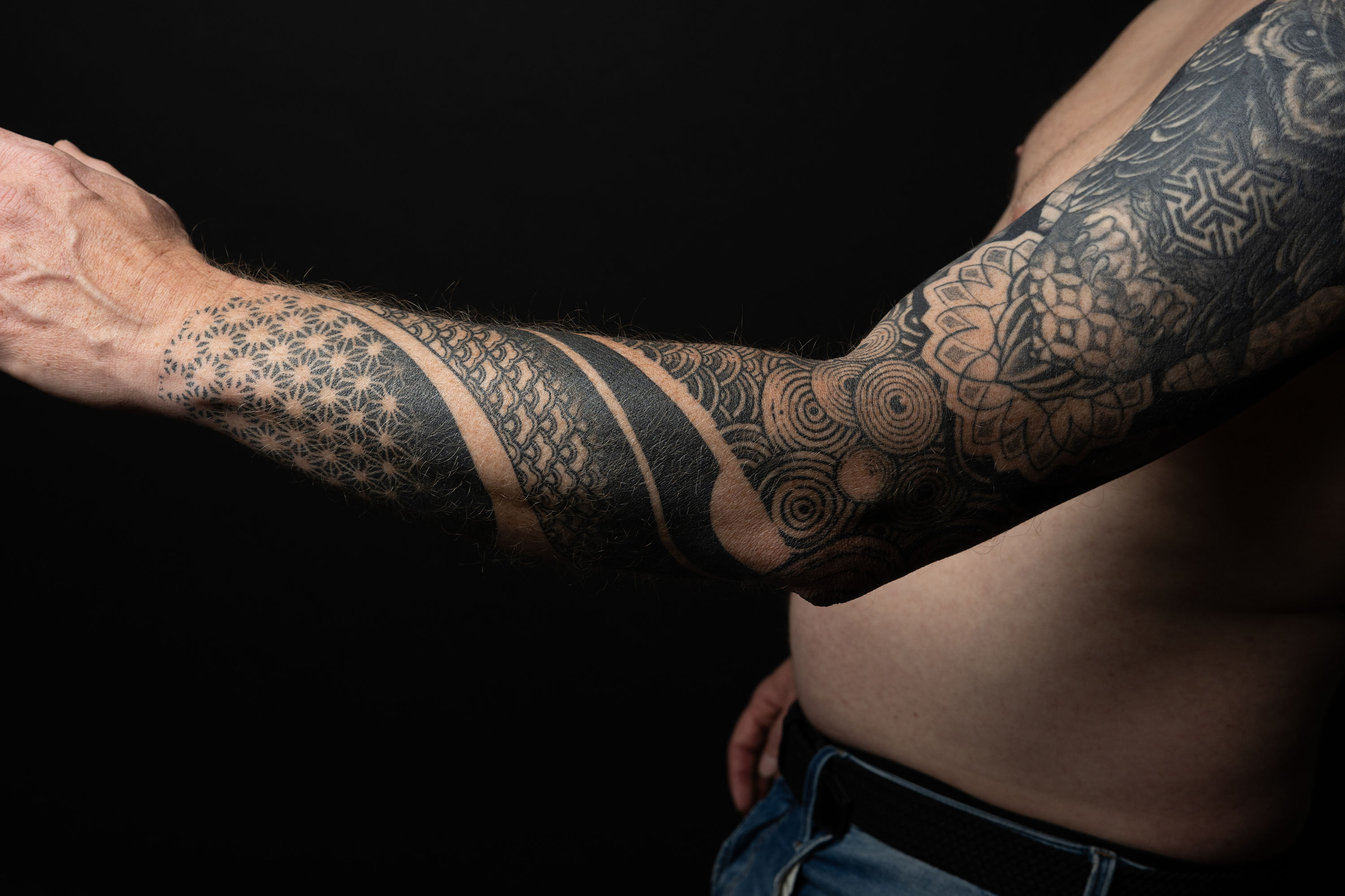 Intriguing black tattoo portraying a celestial scene of a crescent moon surrounded by stars, blending cosmic beauty with artistic finesse