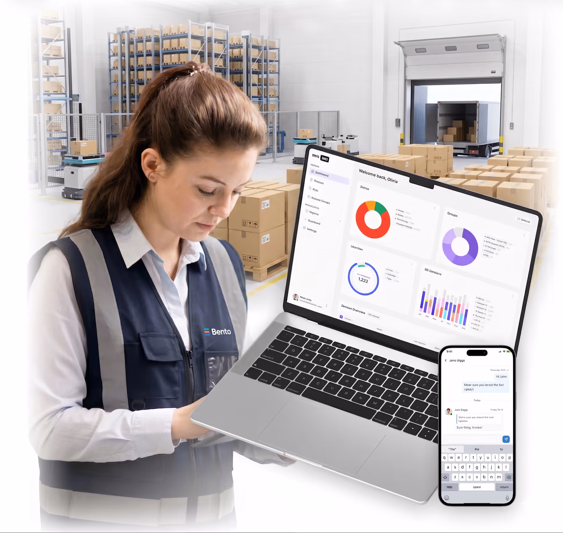 Woman in warehouse wearing Bento vest with laptop showing data charts and smartphone messaging app.