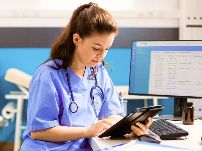 Image showing a doctor using a tablet running Bento MDM software