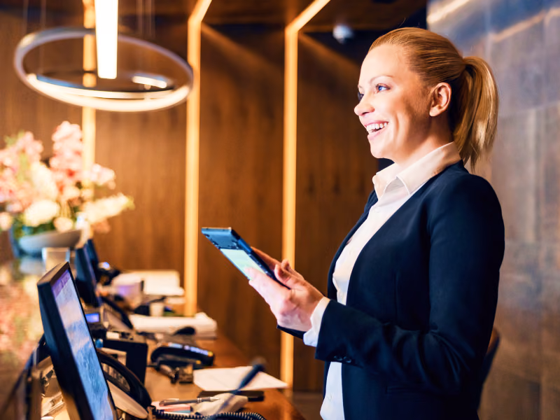Image showing hotel staff using Bento MDM software at a check-in desk