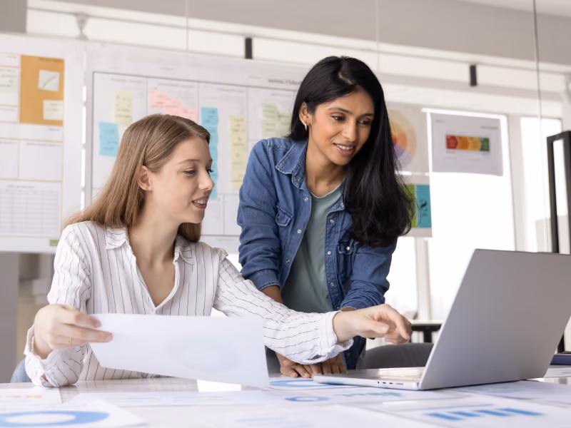 Image showing two people consulting over a laptop running Bento MDM