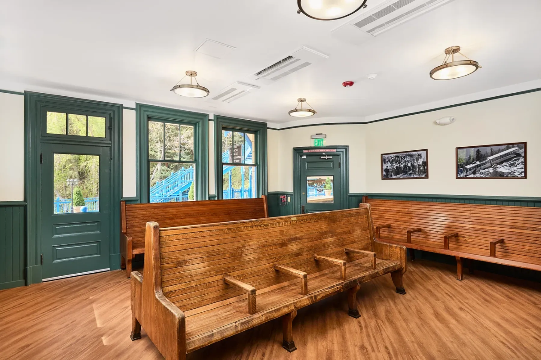 Historic hospitality venue interior with restored wood pew seating and period millwork by Pasley Commercial Interiors, Colorado Springs.