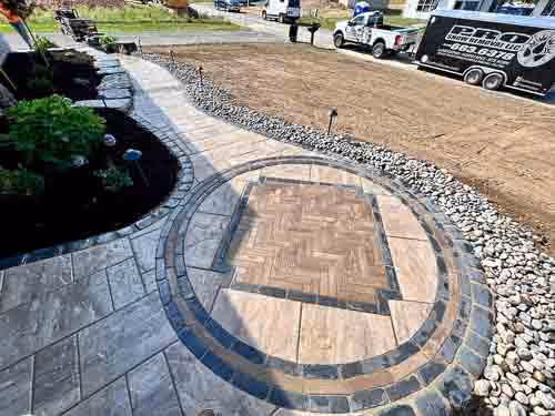 Circular portion of an elaborately curved paver front walkway to a home