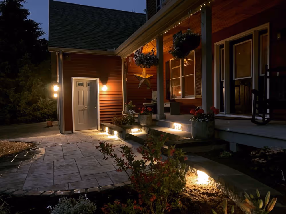 A newly installed stone hardscape walkway in front of relaxing porch installed by PSR