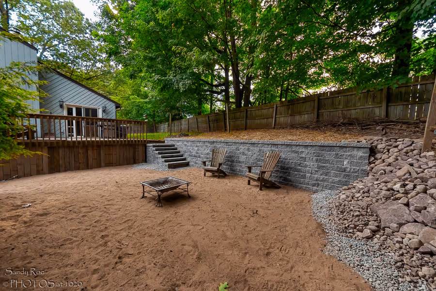 Patio project in Camillus, NY completed by Pro Snow Removal, with a retaining wall and firepit
