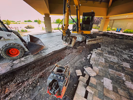 Pro Snow Removal tearing up an old stone entryway at the Abundant Life Church in East Syracuse