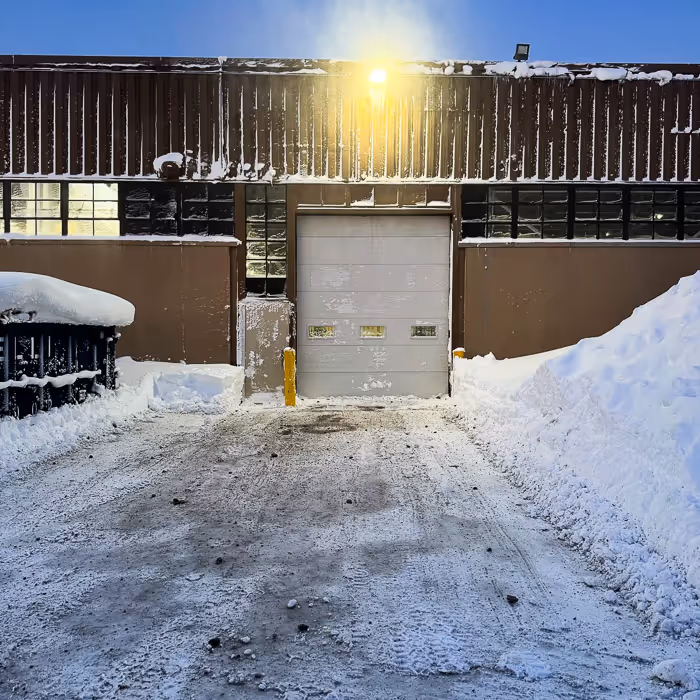 A bay in a Central NY distribution facility that Pro Snow cleared out, with snow piled on the side