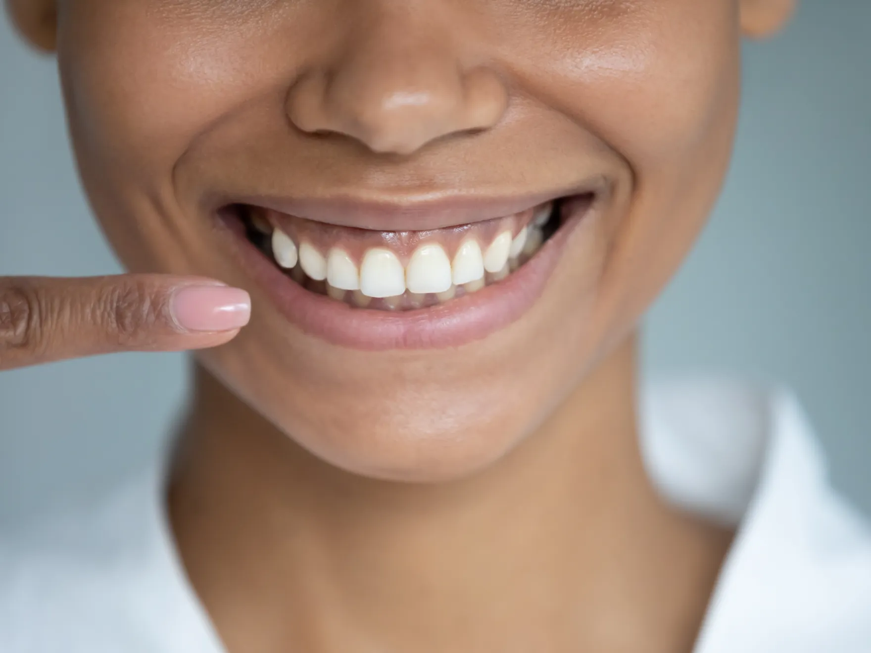 Gum Graftingin Wesley Chapel, Florida | Close up of woman pointing up her healthy smile