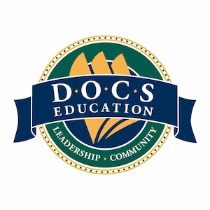 DOCS Education logo with a circular emblem featuring stylized orange sails and a blue banner with text, surrounded by the words Leadership and Community.
