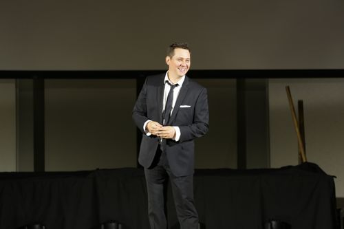 derek selinger on stage laughing