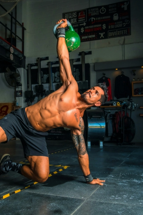 A man performing a kettlebell exercise in a CrossFit gym located in Stamford, CT.