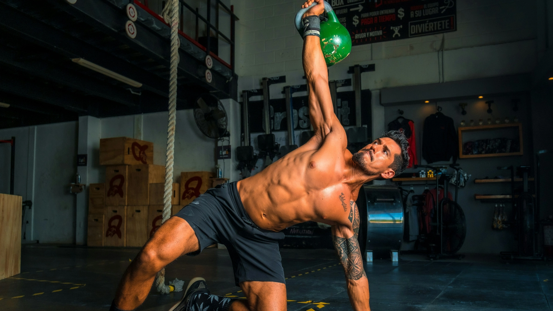 A man performing a kettlebell exercise in a CrossFit gym located in Stamford, CT.