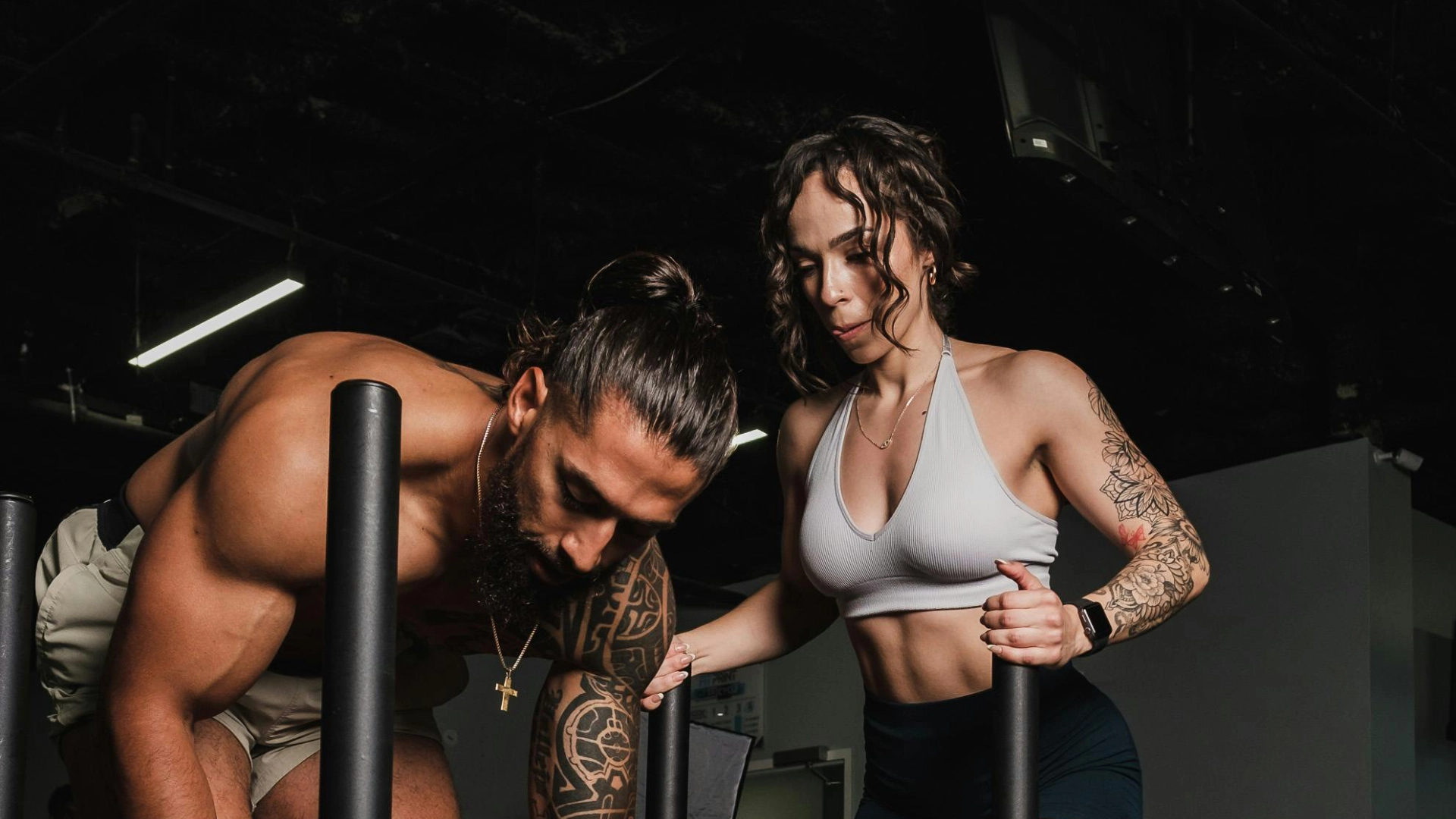 A man and woman perform push-ups in a gym during a personal training session in Stamford, CT.