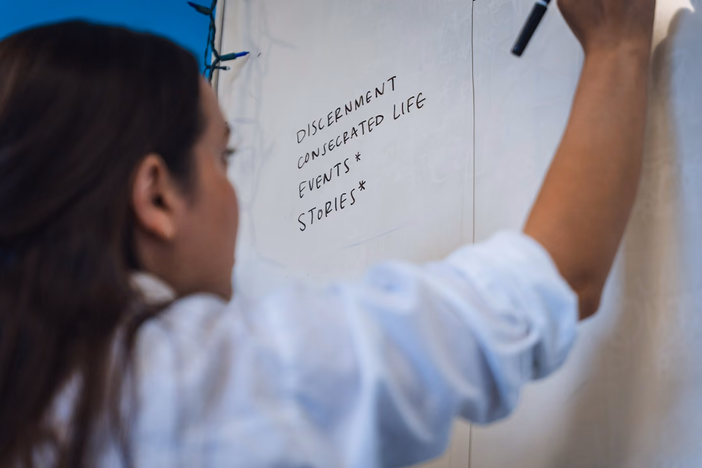 Team member writing on the whiteboard
