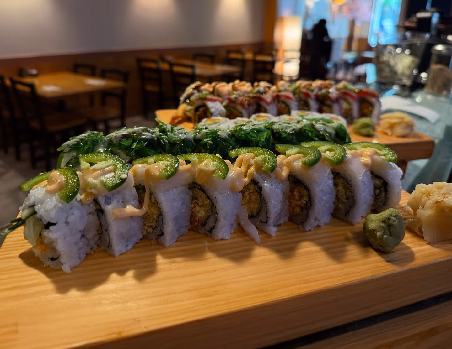 A sushi roll placed on a wooden board.
