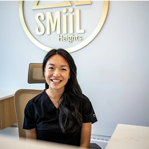 Friendly SMiiL Heights dental hygienist, welcoming patients at the front desk in Calgary dental hygiene clinic