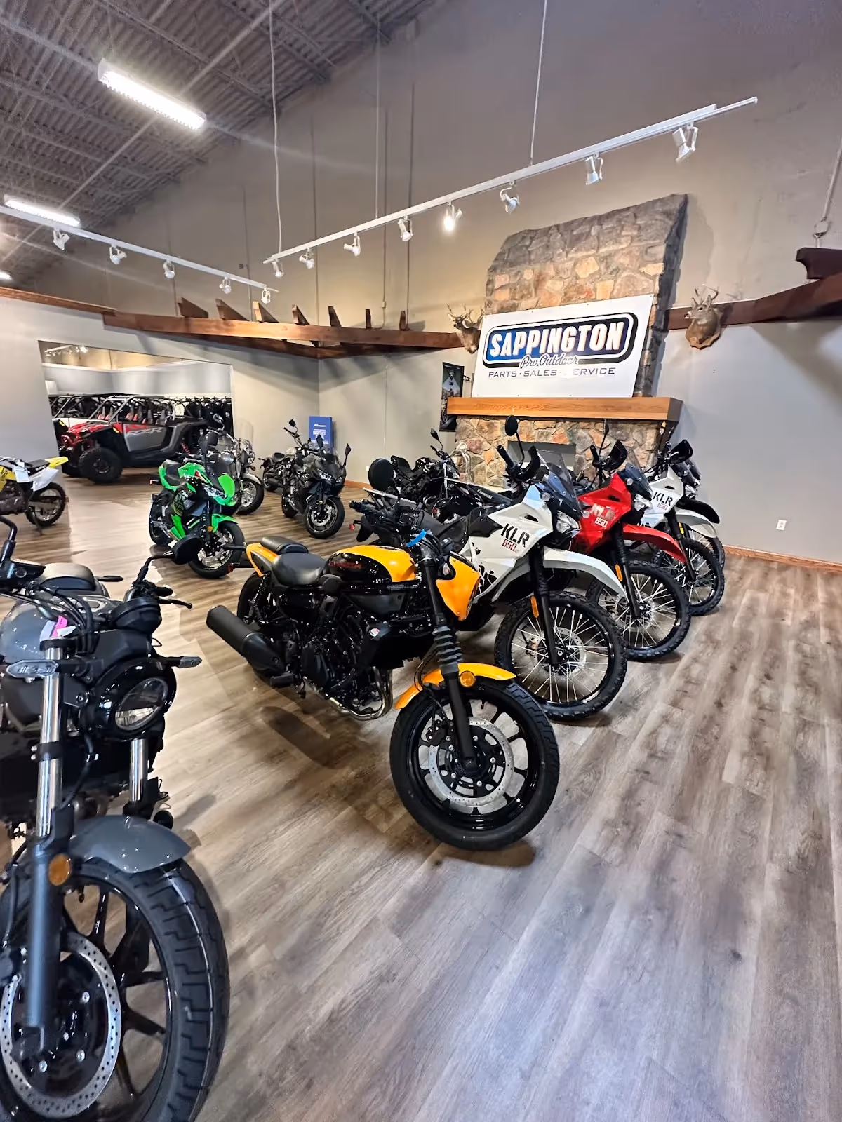 Rows of motorcycles inside the showroom of Sappington Pro