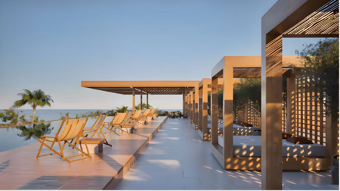 Modern outdoor pool area with wooden lounge chairs and shaded cabanas under a clear sky.