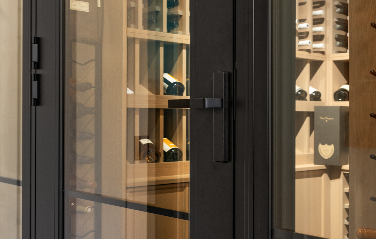 Open aluminium casement windows by Rodney Aluminium, featuring a sleek light-colored frame and clear glazing, with leafy green outdoor foliage visible through the glass.