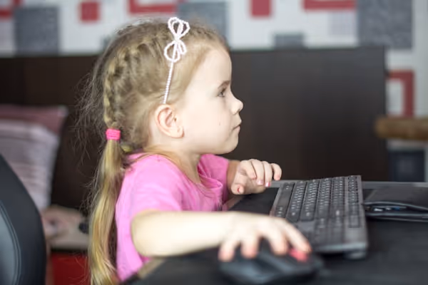 Schoolgirl studying homework math during her online lesson at home.