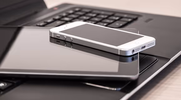 electronic devices like a phone, tablet, and laptop
