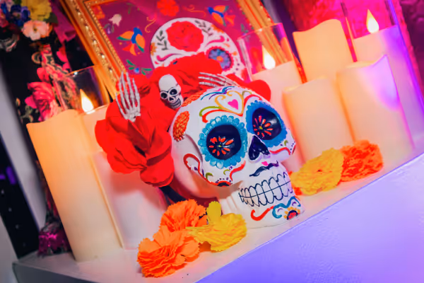 Day of the Dead sugar skull altar with candles and marigold flowers at Azia Restaurant & Lounge Halloween event in Aruba