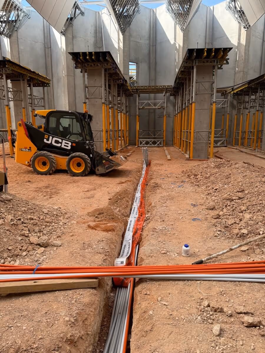 A construction site with a JCB skid steer loader