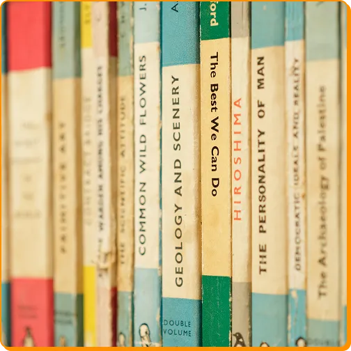 blurred row of vintage book spines including "Geology and Scenery" and "Hiroshima."