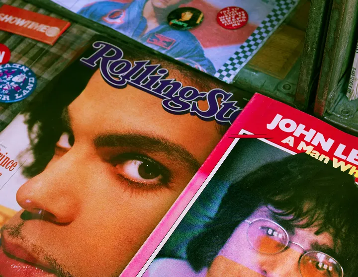 Rolling Stone magazine cover featuring artist Prince next to a John Lennon magazine.