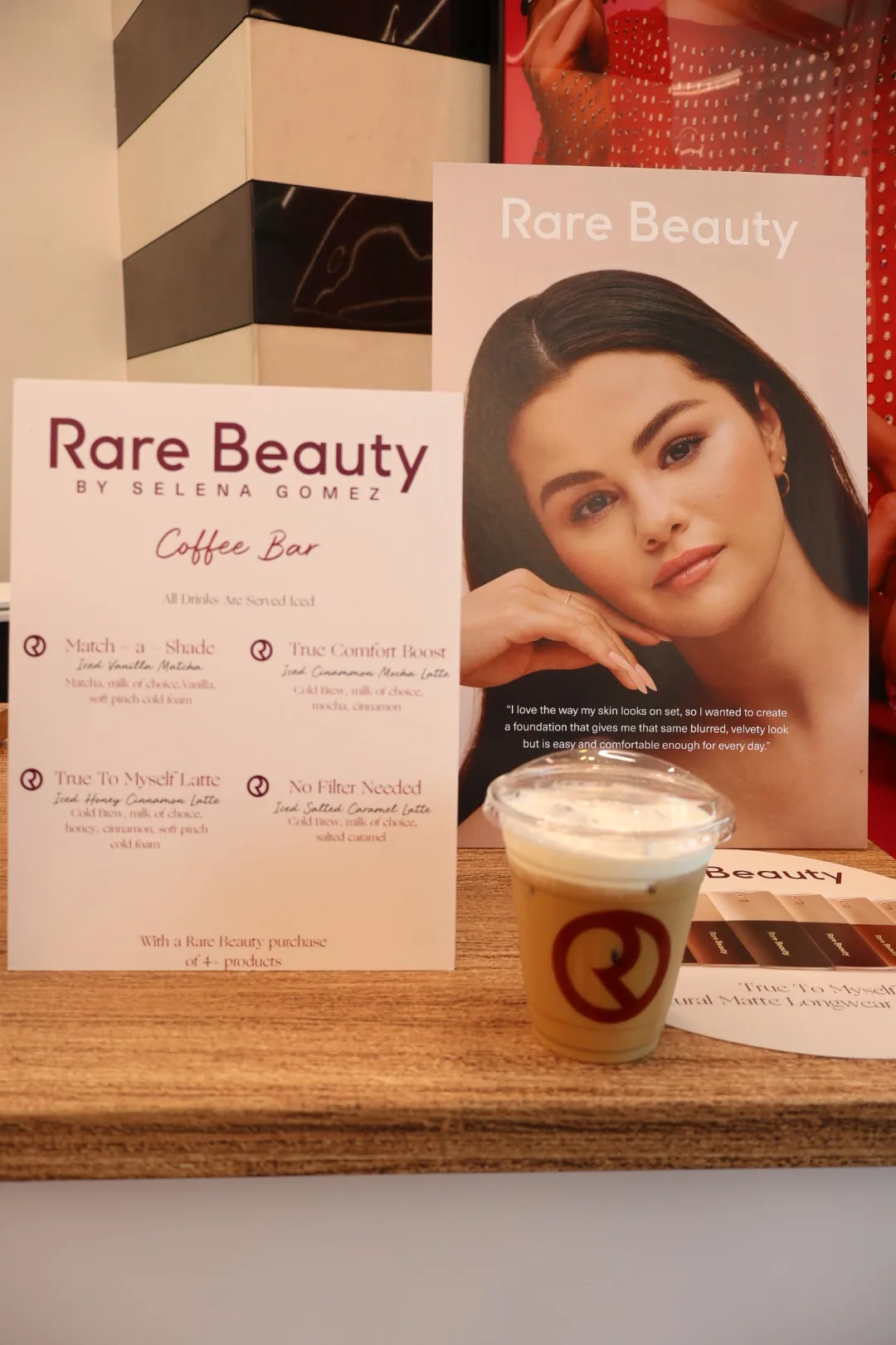 Custom Rare Beauty coffee bar menu with branded drink names at the Disney Springs activation