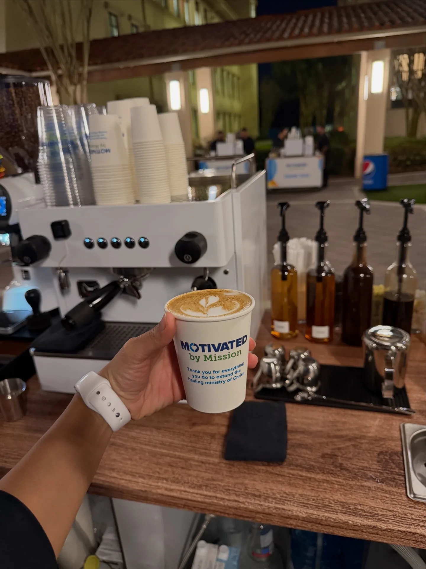 Branded AdventHealth Motivated by Mission coffee cup with latte art at the caregiver appreciation event