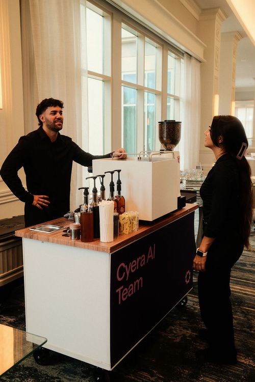 Take a Shot Coffee barista at the Cyera AI Team espresso cart inside the Waldorf Astoria Orlando