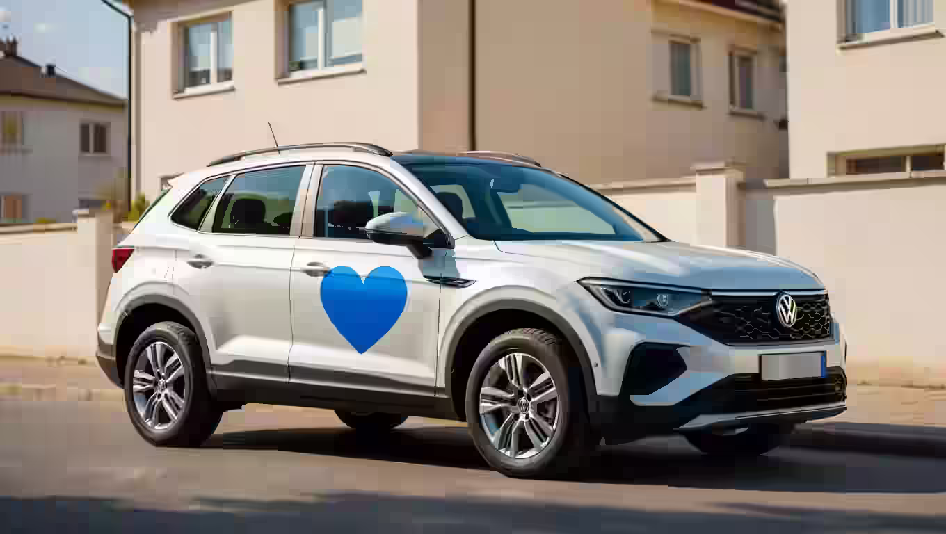 SUV with blue heart on side door, parked outside a house.