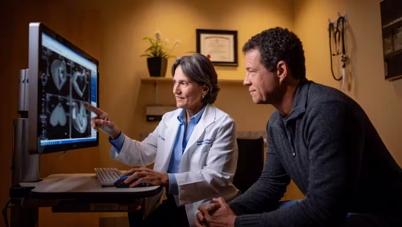 Female cardiologist showing a male patient his ecg on a monitor