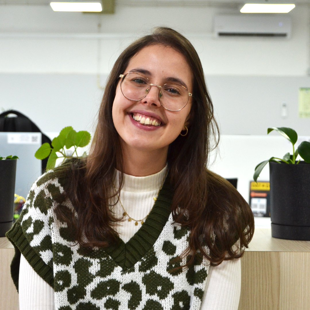 Minimalist illustration of a small village, featuring orange plus and dot symbols.