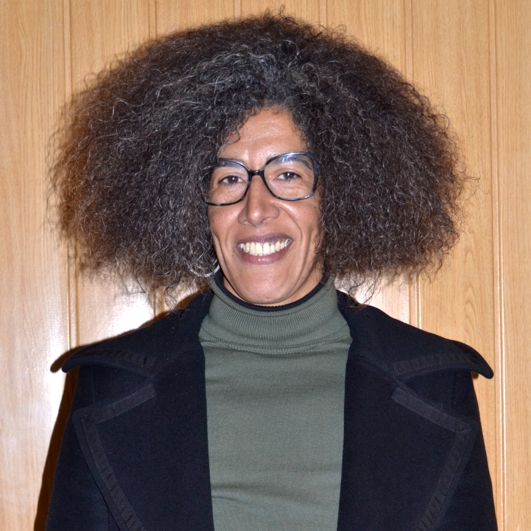 Minimalist illustration of a small village, featuring orange plus and dot symbols.