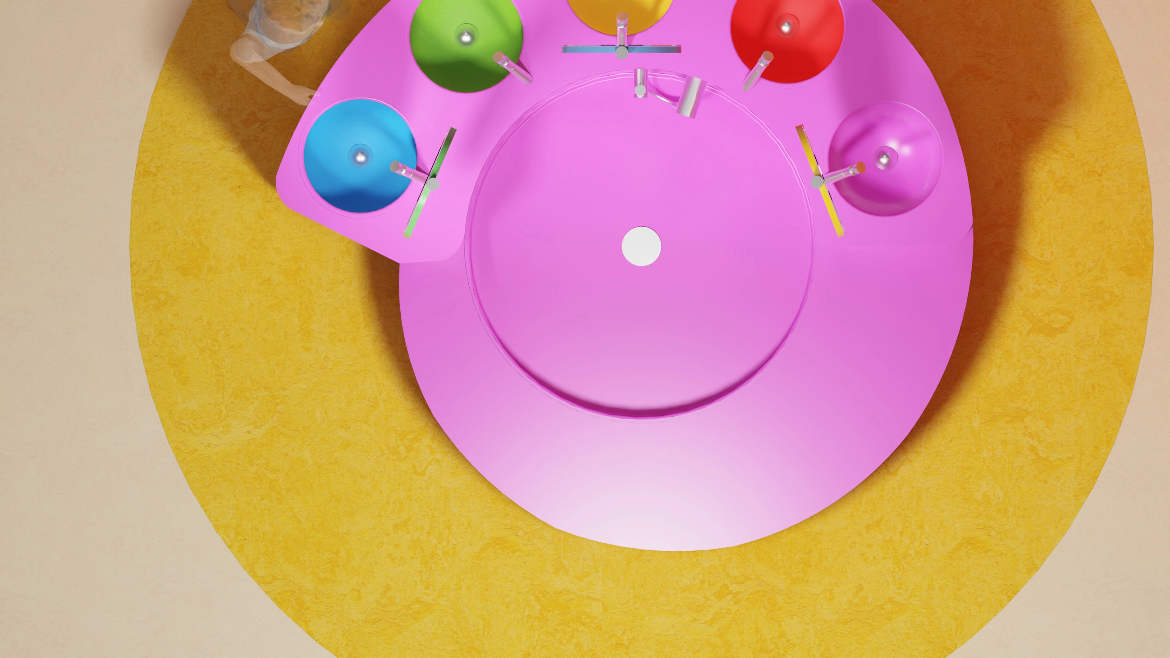 Top-down view of a colorful circular sink unit with multiple faucets and basins in blue, green, yellow, red, and purple on a yellow circular floor mat.