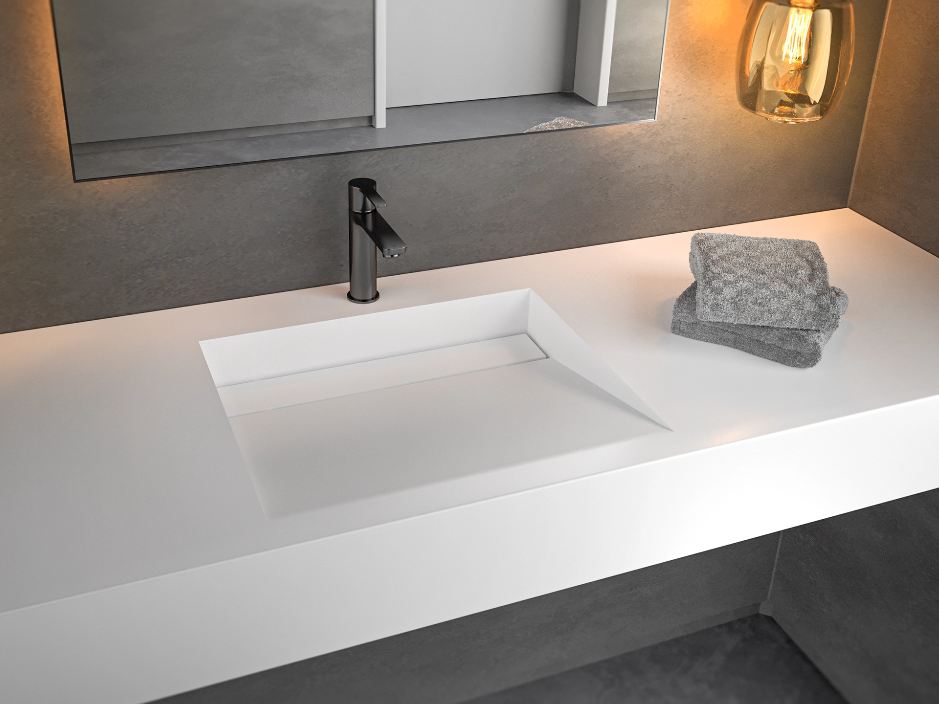 Modern white bathroom sink with black faucet and two folded gray towels on the right side under a rectangular mirror and a warm light fixture.