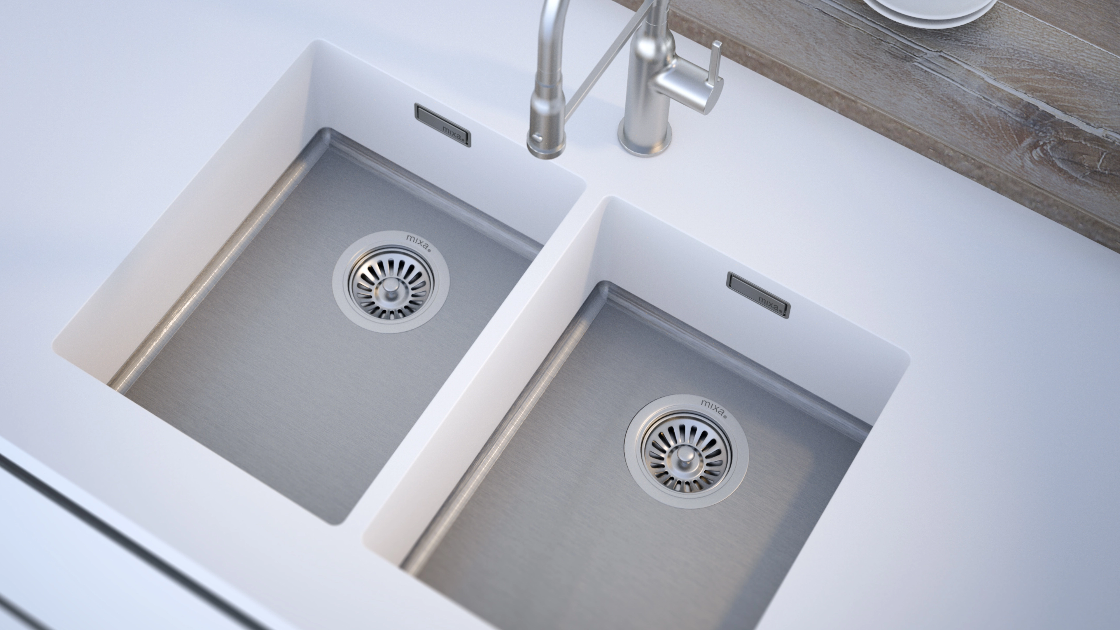 Modern double kitchen sink with stainless steel basins and chrome faucet on a white countertop.