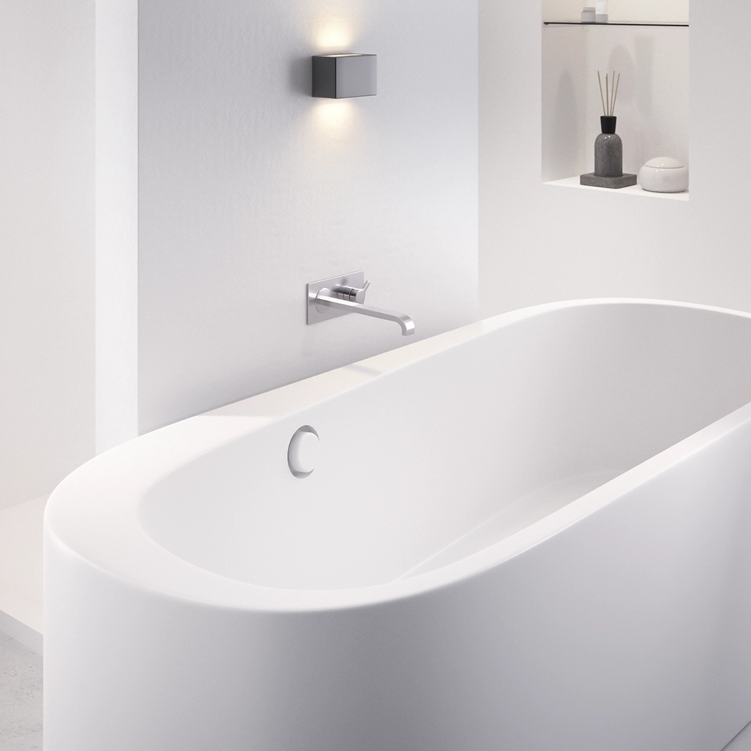 Minimalist white freestanding bathtub with wall-mounted faucet and modern square light above in a bright bathroom.