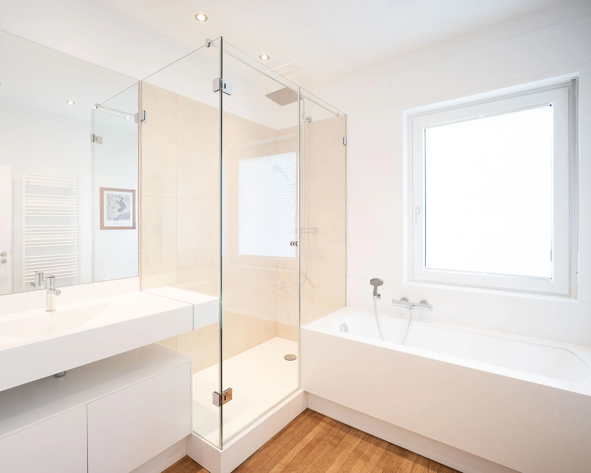 Bright modern bathroom with a glass-enclosed shower, white bathtub, floating sink, and wooden floor.