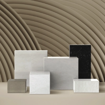 Six rectangular and square stone slabs in various neutral shades arranged on a flat surface against a background of concentric arch patterns.