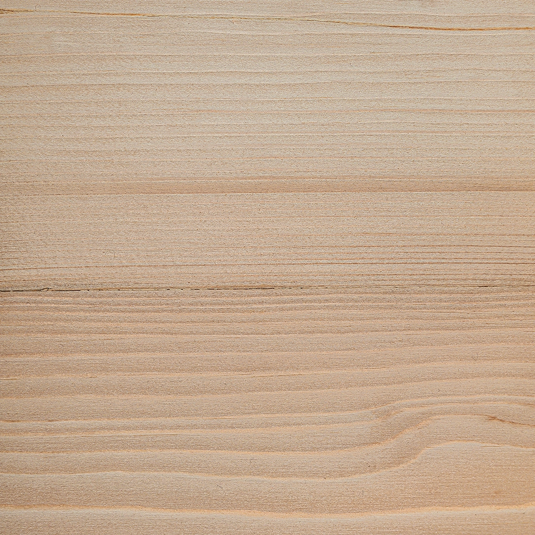 Close-up view of smooth, light-colored wooden surface with natural grain patterns.