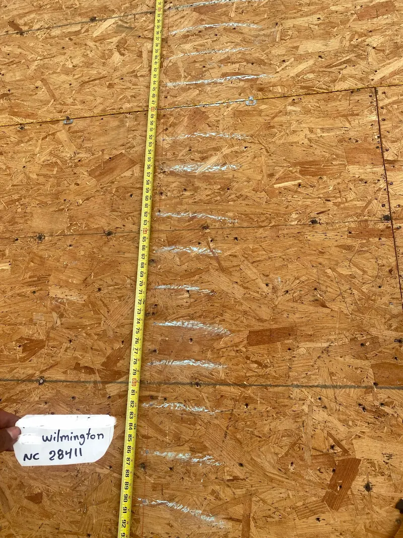 Fortified Plywood Nailing Pattern Wilmington NC holding a piece of paper showing the zip code 28411
