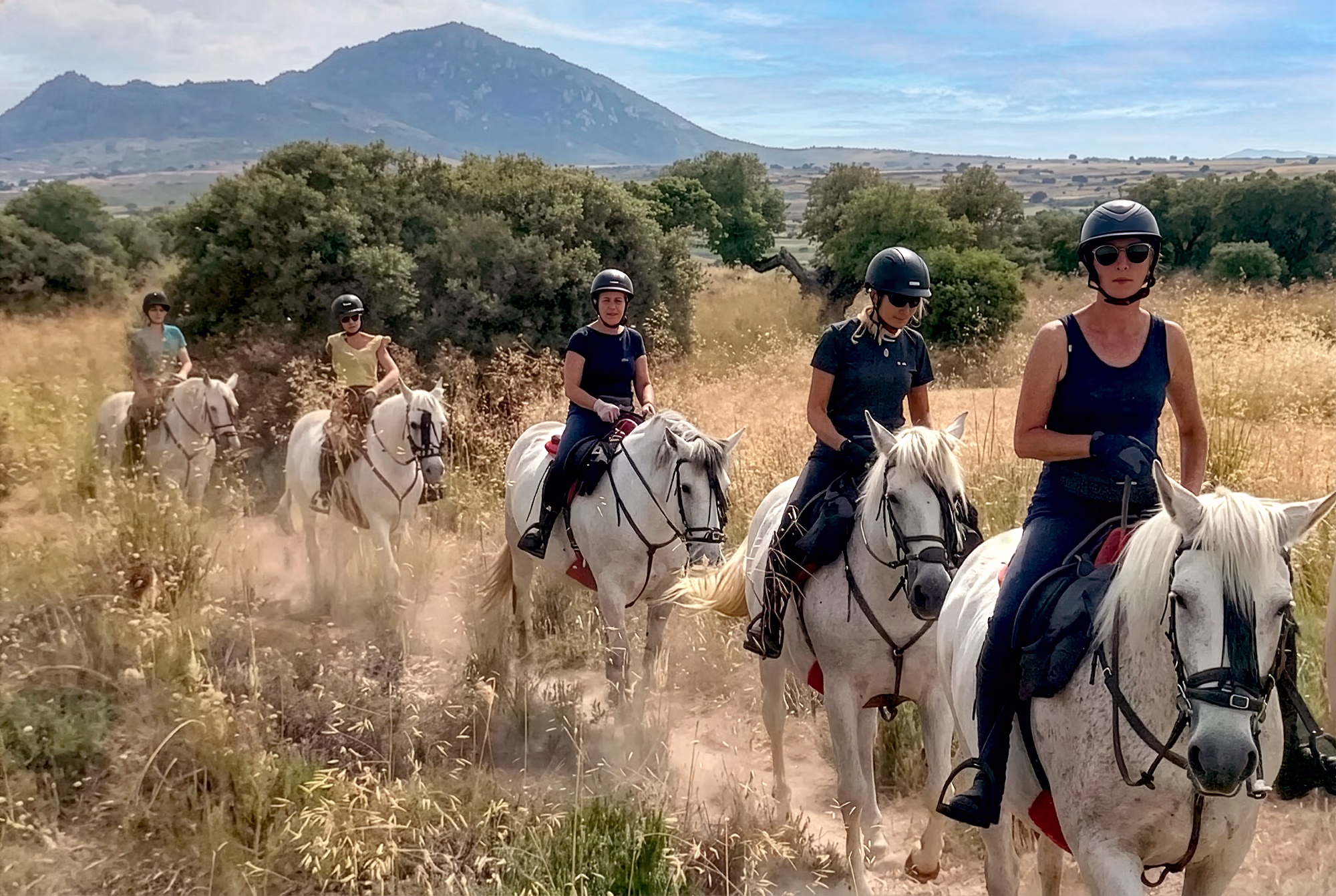 Group of riders on Spanish horses in the Spanish mountains trail riding holiday