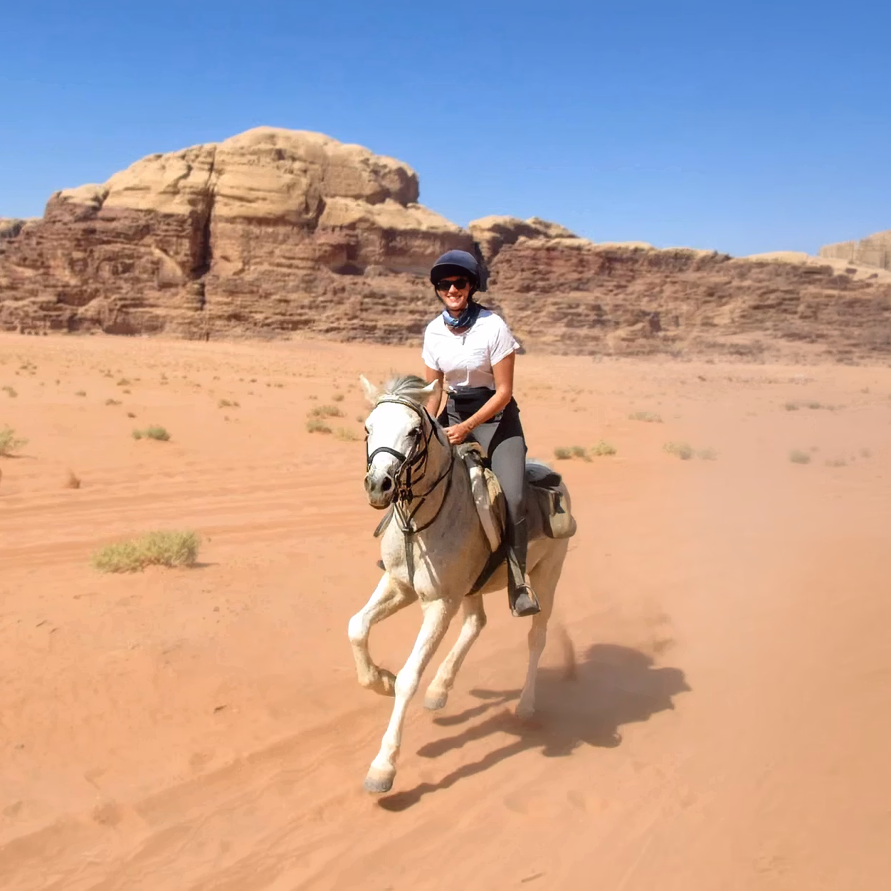 A rider framed against dramatic, sheer unique rock formations
